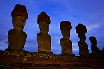 Silhouette of five giant Moai statues at dawn in Ahu Nau Nau, Anakena beach, Easter Island, Pacific ocean, November 2004
