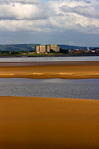 Looking east to Berkeley, decommissioned nuclear power station, with exposed sand banks on bed of Severn estuary, Gloucestershire, England, UK April 2010