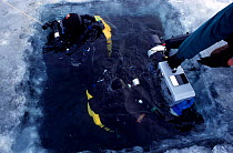 Rebreather instructor Ian Thomas and cameraman Didier Noirot prepare to dive and film under the ice, Lake Baikal, world's deepest and oldest (and largest by volume) freshwater lake, Siberia, Russia. B...
