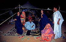 Group of Mauritanian nomads gathering in their tents in the evening, SW Mauritania, February 2004.