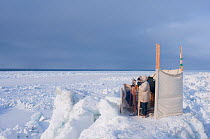 Scientists conducting Bowhead whale (Balaena mysticetus) survey, count passing whales during their spring migration, Chukchi Sea, off shore from Barrow, Alaska. April 2009 NB:This  survey is conducte...