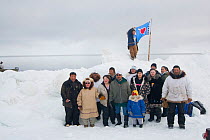 Subsistence whaling family from the Inupiaq arctic village of Barrow, pose for a photo after catching a bowhead whale in springtime, on the pack ice over the Chukchi Sea, off the coast of Alaska, USA....
