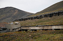 Run-down transport system and boardwalk in the Russian coal mining settlement of Barentsburg, Spitsbergen, Norway, Europe. July 2009