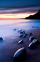 Eype beach at sunset and Dorset coastline, nr Bridport, Dorset, England, UK. February 10.