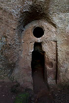 Entrance to the church / hermitage / stone chapel of Poggio Conte, excavated in tufa rock and painted. Lazio 'Maremma', Italy. April 2009