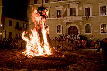 People celebrating with the ceremonial bonfires of Saint Joseph's Night. Such events are held around the vernal equinox, have a clear pagan origin and pay homage to the sun. Pitigliano, Tuscany, Italy...