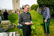 Vicar and people of Henllan village 'Bee Friendly Project'  planting Cowslips (Primula Veris) in churchyard to attract wild and honey bees, organised by North Wales Wildlife Trust and Cadwyn Clwyd, Co...