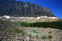 Glacial moraine with a small tarn and conifer forest and the Rockwall behind, Kootenay National Park, British Columbia, Canada. World Heritage Site July 2007