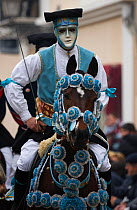 Portrait of a masked rider on a horse (Equus caballus) from the Gremio di Falegnami parades before the start of the 'Sartiglia' (race to the star)  in Oristano, Sardinia, Italy. February 2010