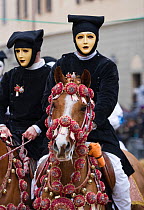 Portrait of two masked riders on  horses (Equus caballus) from the Gremio di Falegnami parades before the start of the 'Sartiglia' (race to the star)  in Oristano, Sardinia, Italy. February 2010