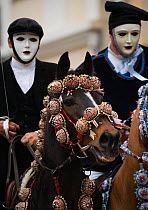 Two riders on horses (Equus caballus) from the Gremio di Falegnamii, dressed in traditional costume, parade before the start of the Sartiglia (race to the star)  in Oristano, Sardinia, Italy. February...