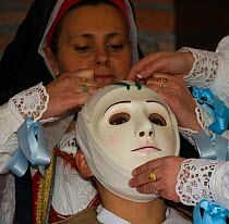 During the dressing of the Gremio di Falegnami, 'Su Cumponidori' the head of the 'Sartiglia' (race to the star) is officially dressed in the traditional costume and mask in Oristano, Sardinia, Italy....