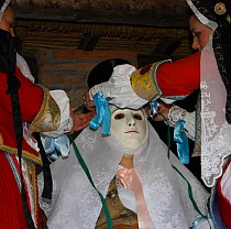During the dressing of the Gremio di Falegnami, 'Su Cumponidori' the head of the 'Sartiglia' (race to the star) is officially dressed in the traditional costume  and mask in Oristano, Sardinia, Italy....
