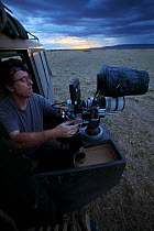 Martin Dohrn operating camera for filming at night, Masai Mara, Kenya, 2009,~Can only be used if National Geographic ^Night of the Lion^ is mentioned.