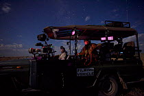 Alex Verner and Clinton Edwards in filming vehicle by moonlight, on location for ^Night of the Lion^, 2009. Thermal camera technology was used to film lions at night.~Can only be used if National Geog...