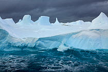 Iceberg with flock of Adelie penguin in the background, Antarctica, January 2009