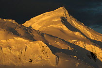 Sunset illuminates Antarctic peaks in the vicinity of Adelaide Island and the Arrowsmith Peninsula. Antarctica, February 2009