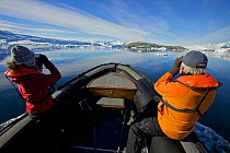 Oceanites Researchers, Heather Lynch and Ron Naveen, approach the Fish Islands in a zodiac boat to conduct counts of breeding penguins. Antarctica, February 2009