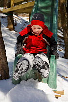 Boy (5 years) sliding into a pile of snow, Lexington, Massachusetts, USA, February 2006, model released