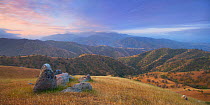 Tehachapi mountains at sunrise, with rolling golden hills and oak trees,  California, USA. April 2009