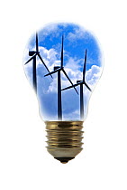 Wind farm turbines against cloudy sky seen inside incandescent lamp / bulb against white background~Digital composite