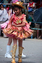Young girl dancing during parade performance at the Oruro Carnival, the biggest annual cultural event in Bolivia, with Morenada music and dancing originating from the Bolivian Andes, Bolivia, South Am...