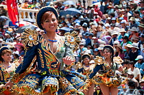 Dancers performing in the streets with crowd of spectators at the Oruro Carnival. This is the biggest annual cultural event in Bolivia, with Morenada music and dancing originating from the Bolivian An...