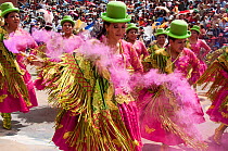 Dancers performing in the streets with crowd of spectators at the Oruro Carnival. This is the biggest annual cultural event in Bolivia, with Morenada music and dancing originating from the Bolivian An...