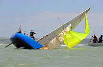Crew attempting to right "Flashheart" on day 2 of the Coutts Quarter Ton Cup. Cowes, England, UK, June 2010.