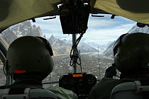 Rear view of pilots and glacier in the Karakoram Mountains, Himalayas, Pakistan, from Pakistani military helicopter, for BBC series Planet Earth. April 2005