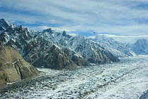 Aerial view of a glaciated valley, Concordia in the Karakoram Mountains, with helicopter in distance. Himalayas, Pakistan. From Pakistani military helicopter for BBC series Planet Earth, April 2005