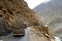 Lorries on road in the Karakoram Mountains, Himalayas, Pakistan. Planet Earth, April 2005