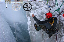 Cameraman Ted Giffords working in crevasse in Gorner glacier, near Zermatt in the Swiss Alps, Switzerland, for BBC Planet Earth series, Mountains episode, 2006. (Vertical dolly filming system)