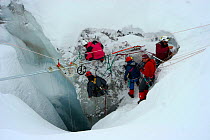 Camera crew working in crevasse in Gorner glacier, near Zermatt in the Swiss Alps, Switzerland, for BBC Planet Earth series, Mountains episode, 2006. (Vertical dolly filming system)