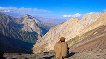 Local scout searching for Snow leopard (Panthera uncia) in the Hindu Kush, North West frontier, Pakistan. For BBC Planet Earth series, 2005.