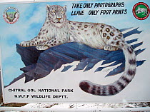 Chitral National Park sign depicting a Snow leopard (Panthera uncia) in the Hindu Kush, North West frontier, Pakistan, on location for BBC Planet Earth series, 2005.