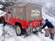 Moving film crew vehicle back onto road in the Hindu Kush, North West frontier, Pakistan, on location filming for BBC Planet Earth series, 2005.