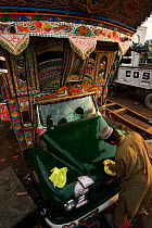 Lorry driver polishing his vehicle, Peshawar, Pakistan, Asia 2005
