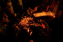 People lighting candles inside Mosque at night, Lahore, Pakistan, 2006