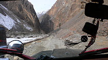 View from jeep on way into Chitral valley to film Snow leopard (Panthera uncia) Hindu Kush, Pakistan. For BBC Planet Earth series, Mountains episode, 2005