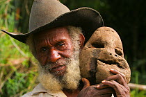 Portrait of Huli tribesman holding symbolic moon rock. He helped filmakers in the areas where Birds of Paradise were filmed for  BBC Planet Earth, Jungles episode, 2005