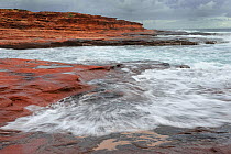 View of waves hitting red bluff coastal cliffs, Kalbarri National Park, Western Australia. August 2009