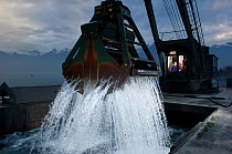 Machine being operated to take gravel at the bottom of Lake Leman, Grangettes, Switzerland, Europe. February 2008.