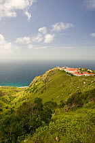 View of coastline and school buildings, The Bottom, Saba Island in the Dutch Caribbean, Netherlands Antilles, West Indies. August 2006.