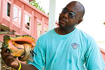 Portrait of Conch Farm tour guide (No Release) holding Conch shell. The only farm of its kind in the world. Provodenciales, Turks and Caicos, Caribbean. June 2007.