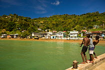 Boys fishing off a dock, Charlotteville in Pirate's Bay on the Caribbean side of Tobago, Caribbean. March 2008 (no release)