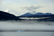 Small iceberg in the fog, Sunshine fjord, Baffin Island, Nunavut, Canada,  August 2010