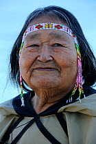 Head portrait of Portrait of Inuit shaman woman, wearing traditional beaded headband / headdress, Pond Inlet, Baffin Island, Nunavut, Canada, August 2010