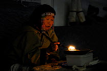 Portrait of Inuit chaman woman burning oil and chanting incantations, Pond Inlet, Baffin Island, Nunavut, Canada, August 2010