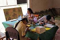 Women creating paper from Asian Elephant (Elephas maximus) dung, elephant orphanage of Pinnawela, June 2010